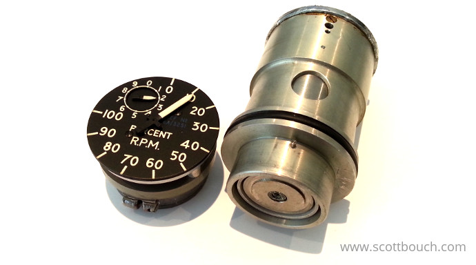Aircraft percent rpm tachometer indicator: Indicator mechanism split from motor